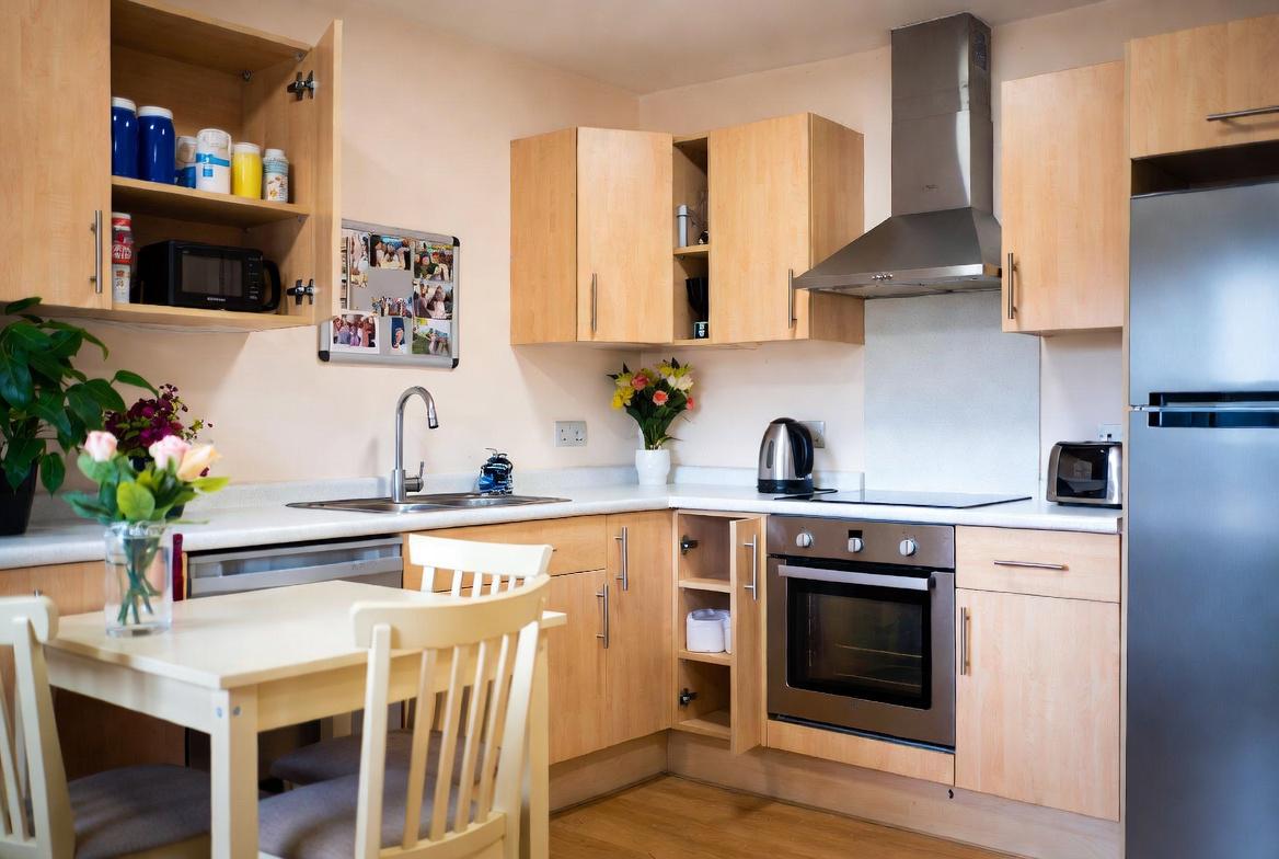 A warm, fully equipped shared kitchen in a Thrive Bucks supported-living home
